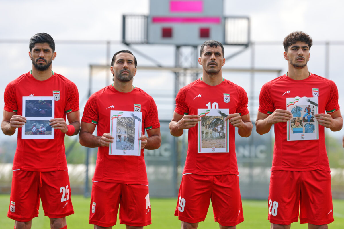 Football: Iranian players take to the pitch against Costa Rica with photos of children killed by bombs